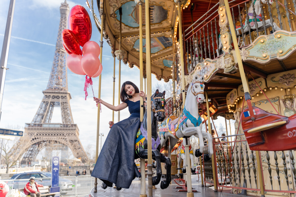 The girl and ballons at Carousel and Eiffel tower