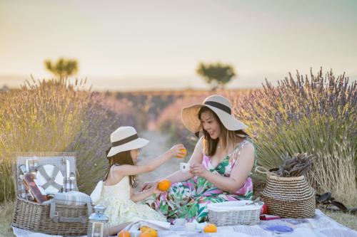 Mother and daughter bonding time at lavender field during sunset