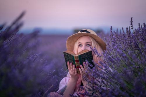Girl and old book at lavender field